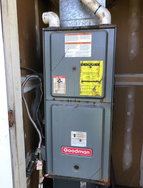 Rusting furnace in exterior closet before replacement